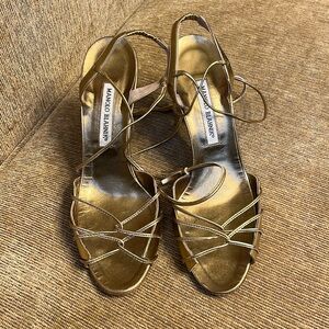 Manolo Blahnik gold heel.